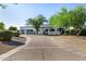 Stunning single story home with white stucco, dark trim, desert landscaping, and a spacious driveway with gated garages at 5404 N 41St St, Phoenix, AZ 85018