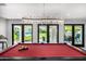Bright game room with pool table, designer lighting, and doors opening up to the outdoor space at 5404 N 41St St, Phoenix, AZ 85018