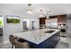 Bright kitchen island with a white countertop, bar seating, stainless appliances, and stylish pendant lights at 5404 N 41St St, Phoenix, AZ 85018