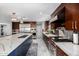Gourmet kitchen with white countertops, stainless appliances, gas cooktop, large island and wood cabinets at 5404 N 41St St, Phoenix, AZ 85018