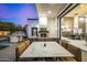 Stylish outdoor dining area with a modern table, a built-in grill, and views of the entertainment area at 5404 N 41St St, Phoenix, AZ 85018