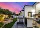 Outdoor kitchen features modern appliances, a built-in grill, and a bar area for entertaining guests in style at 5404 N 41St St, Phoenix, AZ 85018