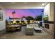 Charming outdoor living area with a stone fireplace, comfortable seating, and a view of the landscaped backyard at 5404 N 41St St, Phoenix, AZ 85018