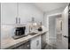 Bright pantry with white cabinets, stainless steel appliances, under cabinet lighting, and marbled countertops at 5404 N 41St St, Phoenix, AZ 85018