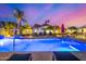 Inviting pool area with comfortable lounge chairs, volleyball net, and vibrant nighttime lighting at 5404 N 41St St, Phoenix, AZ 85018