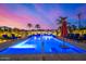 Evening shot of a lavish pool illuminated with vibrant blue lighting and a picturesque sky at 5404 N 41St St, Phoenix, AZ 85018