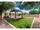 Great backyard featuring artificial turf, a covered patio, and an outdoor BBQ at 5407 S Tatum Ln, Gilbert, AZ 85298