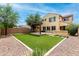Landscaped backyard featuring artificial turf, gravel, a covered patio, and an outdoor BBQ at 5407 S Tatum Ln, Gilbert, AZ 85298