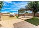 Paver patio with built-in grill, artificial turf, and pergola, perfect for outdoor entertaining at 5407 S Tatum Ln, Gilbert, AZ 85298