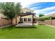 Great backyard featuring artificial turf, a covered patio, and an outdoor BBQ at 5407 S Tatum Ln, Gilbert, AZ 85298