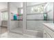 Bright bathroom featuring a glass-door shower, modern tiles and vanity with countertop at 5407 S Tatum Ln, Gilbert, AZ 85298