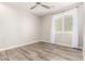 Well lit and airy bedroom featuring hardwood floors, ceiling fan and windows with blinds at 5407 S Tatum Ln, Gilbert, AZ 85298