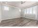 Minimalist bedroom with wood floors features two windows and lots of natural light at 5407 S Tatum Ln, Gilbert, AZ 85298