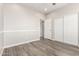 Bright bedroom featuring hardwood floors and a closet with sliding doors at 5407 S Tatum Ln, Gilbert, AZ 85298