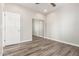 Contemporary bedroom with hardwood floors, ceiling fan and mirrored closet doors at 5407 S Tatum Ln, Gilbert, AZ 85298