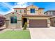 Inviting two-story home featuring a two-car garage, manicured lawn, and well-maintained front yard at 5407 S Tatum Ln, Gilbert, AZ 85298