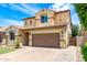 Inviting two-story home with lush landscaping and a brick driveway at 5407 S Tatum Ln, Gilbert, AZ 85298