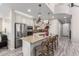 Kitchen features stainless steel appliances, granite countertops, and an island with seating for four at 5407 S Tatum Ln, Gilbert, AZ 85298