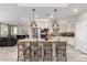 Spacious kitchen with stainless appliances, granite countertops, large island with bar seating, and modern pendant lighting at 5407 S Tatum Ln, Gilbert, AZ 85298