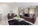 Open-concept living room features stylish furnishings, modern decor, and seamless flow to the kitchen and dining areas at 5407 S Tatum Ln, Gilbert, AZ 85298