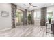 Living room with sliding glass doors, tile flooring, neutral paint and ceiling fan at 5407 S Tatum Ln, Gilbert, AZ 85298
