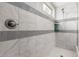 Up close view of the shower with elegant marble tiles and modern showerhead at 5407 S Tatum Ln, Gilbert, AZ 85298