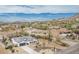 Stunning aerial view of a white home in a desert community with mountain views and a private driveway at 5670 E Singletree St, Apache Junction, AZ 85119