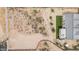 Aerial view of a backyard with artificial turf and a patio area, set in a desert landscape at 5670 E Singletree St, Apache Junction, AZ 85119