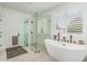 Bright bathroom featuring a modern standalone tub, glass shower, and plantation shutters at 5670 E Singletree St, Apache Junction, AZ 85119