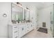 Stylish bathroom with a double sink vanity, black hardware, and a glass-enclosed shower at 5670 E Singletree St, Apache Junction, AZ 85119