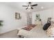 Bright bedroom boasting soft carpet, a ceiling fan, and a charming wooden mirror at 5670 E Singletree St, Apache Junction, AZ 85119