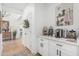 Bright coffee bar with white cabinetry, stylish decor and open view into the rest of the home at 5670 E Singletree St, Apache Junction, AZ 85119