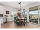 Charming dining room with a wooden table, green chairs, and sliding glass doors at 5670 E Singletree St, Apache Junction, AZ 85119