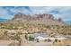 Desert home showcasing beautiful mountain views, landscaping, and a spacious fenced backyard at 5670 E Singletree St, Apache Junction, AZ 85119