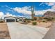 Charming single-story home with a two-car garage and a well-manicured desert landscape at 5670 E Singletree St, Apache Junction, AZ 85119