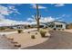 Inviting single-Gathering home with desert landscaping, a circular driveway, and a side entrance at 5670 E Singletree St, Apache Junction, AZ 85119