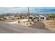 Charming single-Gathering home featuring a front yard with mature landscaping and a long driveway at 5670 E Singletree St, Apache Junction, AZ 85119