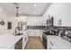 Bright kitchen with white cabinets, stainless steel appliances, and dark hardware at 5670 E Singletree St, Apache Junction, AZ 85119