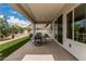 Covered patio with a dining table and chairs overlooking a manicured lawn and mountain views at 5670 E Singletree St, Apache Junction, AZ 85119