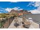 Relaxing outdoor patio with mountain views, comfortable seating, and metal railings for safety at 5670 E Singletree St, Apache Junction, AZ 85119