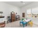 Bright playroom with natural light, charming vintage decor, and furniture at 5670 E Singletree St, Apache Junction, AZ 85119