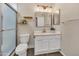 Bright bathroom features updated vanity, floating shelves, and tiled shower with glass door at 5808 E Brown Rd # 49, Mesa, AZ 85205