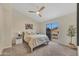 Bright main bedroom with ceiling fan, sliding glass doors, and plush carpet at 5808 E Brown Rd # 49, Mesa, AZ 85205