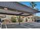 View of the covered parking area featuring a carport and landscaped dividers at 5808 E Brown Rd # 49, Mesa, AZ 85205