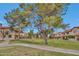 Community green space with walking path, lush landscaping, and well-maintained home exteriors at 5808 E Brown Rd # 49, Mesa, AZ 85205