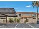 Charming condo exterior with covered parking, desert landscaping, and inviting courtyard entry at 5808 E Brown Rd # 49, Mesa, AZ 85205