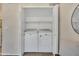 Bright laundry closet with white Maytag washer and dryer, plus useful shelving at 5808 E Brown Rd # 49, Mesa, AZ 85205