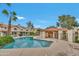Community pool with lounge chairs, desert landscaping, and a nearby cabana at 5808 E Brown Rd # 49, Mesa, AZ 85205
