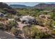 Stunning aerial view of a luxurious home nestled in the mountainside with desert landscape at 6102 E Sage Dr, Paradise Valley, AZ 85253