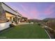 Expansive backyard featuring a patio, artificial turf, and outdoor fire pit at 6102 E Sage Dr, Paradise Valley, AZ 85253